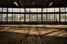 an empty warehouse with lots of windows and no people in the room or on the floor