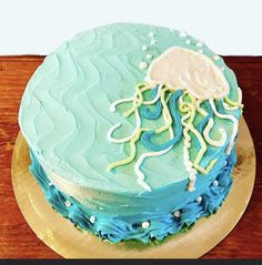 there is a cake with blue icing and a jellyfish on it