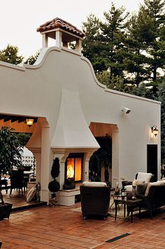 an outdoor patio with furniture and a fire place