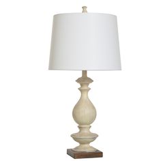 a white lamp with a wooden base and a white lampshade on the side