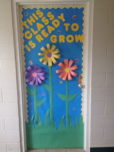 a door decorated with paper flowers and the words, this is great to grow on it