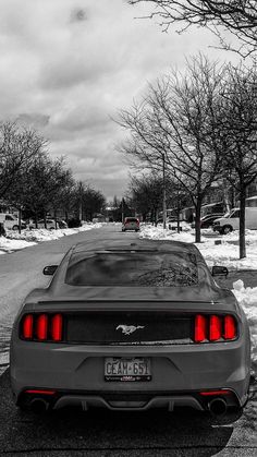 a car parked on the side of a snow covered road