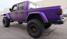 a purple jeep parked in front of a building