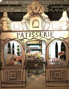 the entrance to patisserie is decorated in gold and white