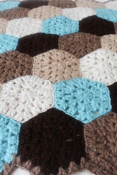 there is a crocheted blanket on the floor that looks like hexagonals