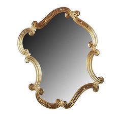 an ornate gold framed mirror against a white background