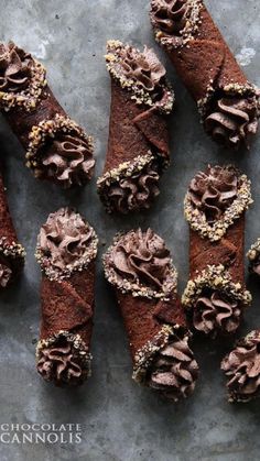 chocolate pastry sticks with sprinkles arranged on a gray surface, ready to be eaten