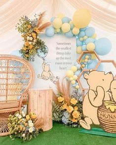 winnie the pooh birthday party with balloons, flowers and decorations on green carpeted area