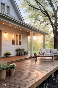 a deck with potted plants and lights on it