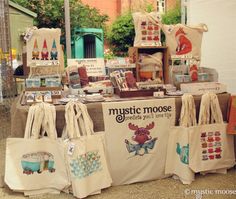 many bags are on display at an outdoor market