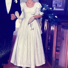 a man and woman in formal wear standing next to each other