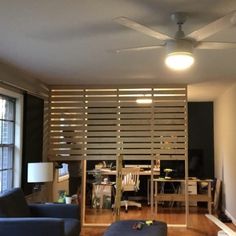 a living room filled with furniture and a ceiling fan