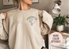 This Pickleballer Crewneck is the perfect birthday gift or Christmas gift for all women! All of our sweatshirts are made with the highest quality materials and are super soft and cozy! 💚 HOW TO ORDER 💚 1. Check our photos for sizing and color options. 📏 2. Choose your quantity.  Feel free to add as many shirts as you wish! ✨ 3. Select your size and color from the drop-down menus. ✨ 4. Click "ADD TO CART" to add the shirt to your virtual cart. 🛒 5. Click "PROCEED TO CHECKOUT" to purchase your shirt. 🛒 6. Your shirt is now off to production!  We will process your order and your shirt will be ready for shipment in 1-4 days! 🎁 📏 SHIRT SIZING All of our shirts come in a variety of colors and many different sizes! ✨ SHIRT INFORMATION + MATERIAL Our unisex crewnecks fit both men and women Perfect Birthday Gift, Perfect Birthday, Pickleball, Cut And Style, Crewneck Sweatshirt, Color Options, Ribbed Knit, Favorite Outfit, Gender Neutral