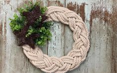 a rope wreath with some plants on it