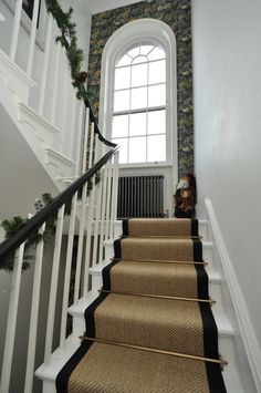 there is a set of stairs with black and tan carpet