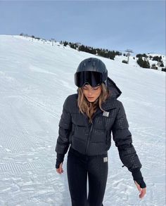 a woman riding skis down a snow covered slope