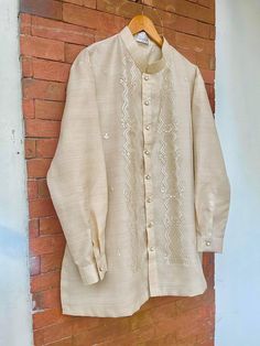 "Classic but modern barong Tagalog. It is made of pinya jusi embroidered fabric. Available and ships from New York, USA. Piña Jusi Fabric-These hand-embroidered fabric is made out of Piña, an intricately hand-woven fabric from pineapple husks and also woven with Cocoon or Silk or Jusilyn. This fabric is commonly use to make \"barongs\" - a formal wear in the Philippines. Famous fabric from Lumban, Laguna Philippines. Embroidery design is fern-like floral, natural ivory color, very classic and tr Embroidered Semi-stitched Traditional Wear For Ceremony, Semi-stitched Embroidered Traditional Wear For Ceremony, White Embroidered Kurta For Ceremony, Embroidered Traditional Drape Kurta For Ceremony, Embroidered Kurta With Traditional Drape For Ceremonies, Traditional Kurta With Resham Embroidery For Ceremonies, Traditional Resham Embroidered Kurta For Ceremony, Traditional Resham Embroidery Kurta For Ceremony, Festive Embroidered Kurta For Ceremony