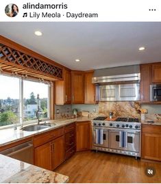 an image of a kitchen setting with wood cabinets and stainless steel appliances in the middle