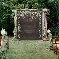 an outdoor ceremony setup with greenery and lights