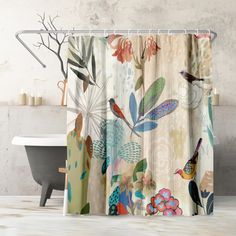 a shower curtain with colorful flowers and birds on it in front of a bathtub