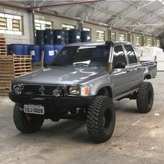 a silver truck parked inside of a warehouse