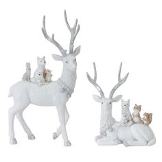 three white deer figurines sitting next to each other