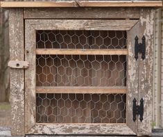 an old wooden cabinet with chicken wire on top