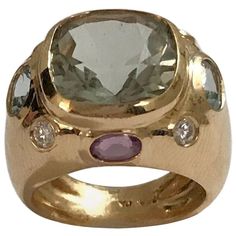 The BONHEUR Ring: 18kt Yellow Gold Domed Ring with faceted 15mm Cushion Cut Green Amethyst center stone and faceted oval Purple Amethyst stones and round Blue Topaz stones. The ring measures 3/4 of an inch across the top. This ring is available in any color stone combination. This ring may be sized. Please contact me with any questions you may have. Best, Christina Addison Fine Jewelry Designs Topaz Yellow, Amethyst Stones, Blue Topaz Stone, Domed Ring, Fine Jewelry Designers, Green Amethyst, Blue Topaz Ring, Gold Diamond Rings, Amethyst Stone