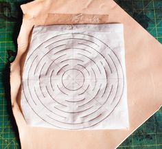 a piece of paper sitting on top of a cutting board next to scissors and tape