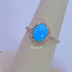 DESCRIPTION:  Thank you for coming in! Spectacular handmade 14K solid yellow gold ring with gem turquoise centers and fine diamond halo(0.36 carat G color, VS-SI clarity). The Sleeping Beauty Turquoise oval Cabochon stone is carefully hand selected from old stock selection, true premium grade! Very unique and classy! It looks much much nicer in person!  Sleeping Beauty Turquoise: 9.7mmx7.2mm, 1.45 carats Total Weight: Appx: 2.28 Grams MATERIAL: 14K Solid Gold ring, Diamond, Sleeping Beauty Turquoise Turquoise Blue Diamond Ring With Center Stone, Fine Jewelry Turquoise With Halo Setting, Turquoise Ring With Halo Setting In Fine Jewelry Style, Fine Jewelry Turquoise Ring With Halo Setting, Turquoise Halo Setting Fine Jewelry Ring, Blue Turquoise Ring With Halo Setting For Anniversary, Turquoise Oval Ring With Halo Setting, Oval Turquoise Jewelry With Halo Setting, Turquoise Oval Jewelry With Halo Setting