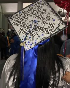 a graduation cap that says no role models and i'm here right now on