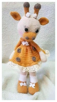 a crocheted giraffe dressed in a yellow dress