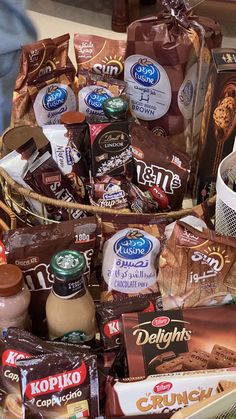 a basket filled with lots of different types of chocolates and other items in it