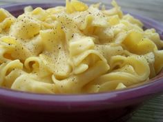 a purple bowl filled with macaroni and cheese