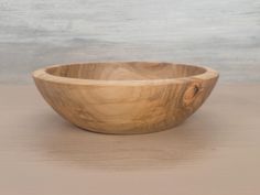 a wooden bowl sitting on top of a table