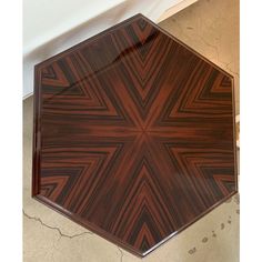 a wooden table with an intricate design on it's top and bottom edge, viewed from above