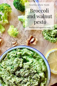 broccoli and walnut pesto in a bowl with lemons on the side