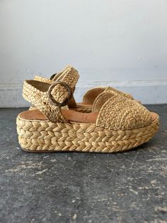 Robert Clergerie Woven Wicker Wedge Sandals. Woven wicker wedge sandals-- say that 10x fast! These are the perfect shoe for your summer fits, elevating a sun dress look or paired with a lightweight trouser. Open toed to show off your pedicure, with a plastic textured buckle at the ankle. Braided straw detail covers the platform throughout. Sole is rubber, vegetable leather padding for the foot. Otherwise made from natural straw. In excellent used condition. Marked size 9.5. Approx. Measurements: Ryan Roche, Vegetable Leather, Robert Clergerie, Ace And Jig, Black Crane, Magnolia Pearl, Summer Fits, Sun Dress, Perfect Shoes