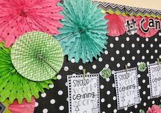 a bulletin board is decorated with paper flowers