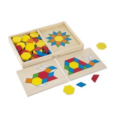 two wooden puzzles in a box with colored blocks and shapes on the floor next to each other