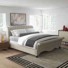 a bedroom with a large bed and two nightstands on either side of the bed