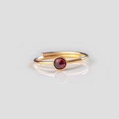 Discover our sustainable 🌿 ring collection - each piece of jewelry is unique with a unique gemstone. A special lucky charm with a very personal meaning. Ideal as a gift or as a personal treat for yourself. Filigree stacking ring with a real garnet. ▸ individually adjustable from size 50 to 58 (EU) ▸ Ideal as a gift thanks to the high-quality jewelry box ▸ The piece of jewelry is made of sustainable recycled 925 sterling silver (optionally gold-plated or rose gold-plated). 🌿 NEW & IMPROVED: NOW WITH 3 MICRON GOLD PLATING ▸ Your 925 gold-plated jewelry now receives a 3 micron thick gold plating for long-lasting joy. ▸ For care tips, please take a look at our FAQs. 🌿 FIND YOUR FAVORITE Looking for another gemstone? Check out our entire ring collection: https://www.etsy.com/de/shop/JenOezer Minimalist Stackable Adjustable Ruby Ring, Dainty Adjustable Ruby Ring Gift, Adjustable Ruby Ring With Round Band As Gift, Garnet And Gold, Sustainable Jewelry, Unique Gemstones, Ring Collections, 925 Silver Rings, Gold Plated Jewelry