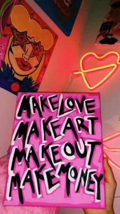 someone holding up a pink box with writing on it that says make out mateoney