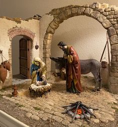 a nativity scene with figurines of jesus and baby jesus