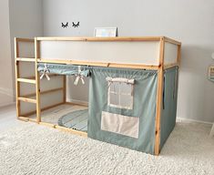 a child's bunk bed with a tent on top