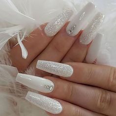 a woman's hand with white acrylic nails