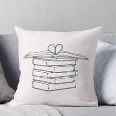 a black and white drawing of a stack of books with a heart on top throw pillow