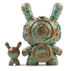 an ornately designed ceramic figurine next to a small statuette in the shape of a rabbit