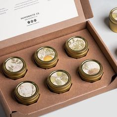 six coins in a box sitting on a table