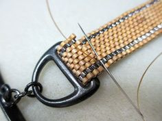 a pair of scissors are hooked up to a piece of woven material that has been stitched together